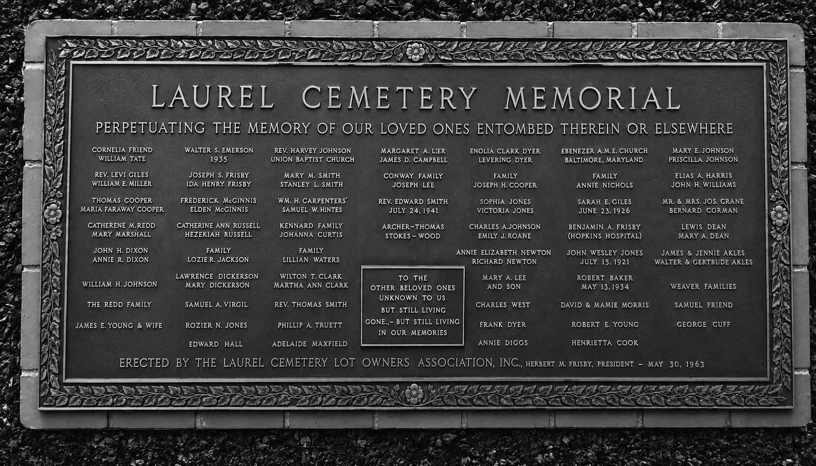 Black-and-white photograph of the 1963 Laurel Cemetery Memorial plaque at Arbutus Memorial Park honoring individuals and families buried at Laurel Cemetery.